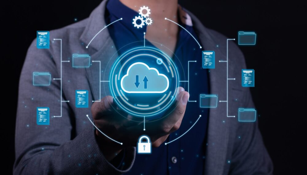 A man employs cloud-based computing on his smartphone to facilitate data transmission and backup.