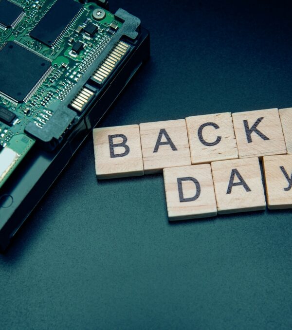 Words in English Backup day. Copy space for text. HDD hard drive. hard disk on black dark background Words in English Backup day. Copy space for text. HDD hard drive. hard disk on black dark background