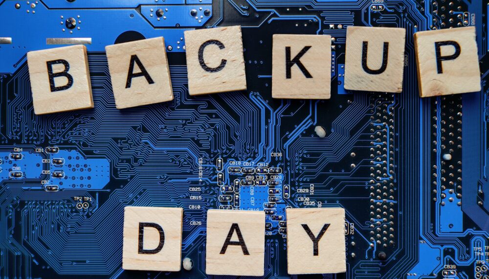 Words in English Backup day. Copy space for text. HDD hard drive. hard disk on black dark background Words in English Backup day. Copy space for text. HDD hard drive. hard disk on black dark background