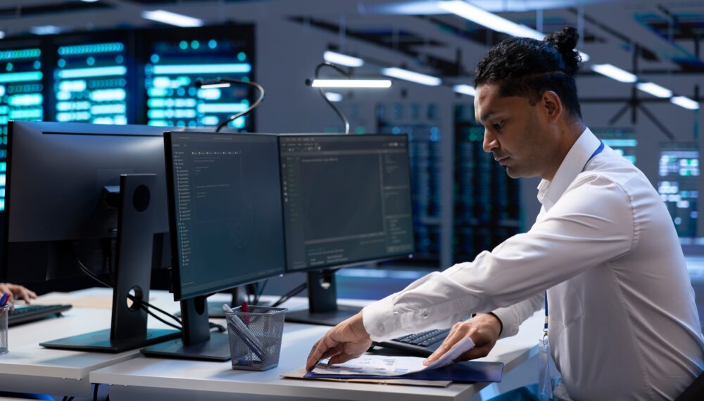 Engineer maintaining accurate documentation of data center infrastructure, Engineer maintaining accurate documentation of data center infrastructure,