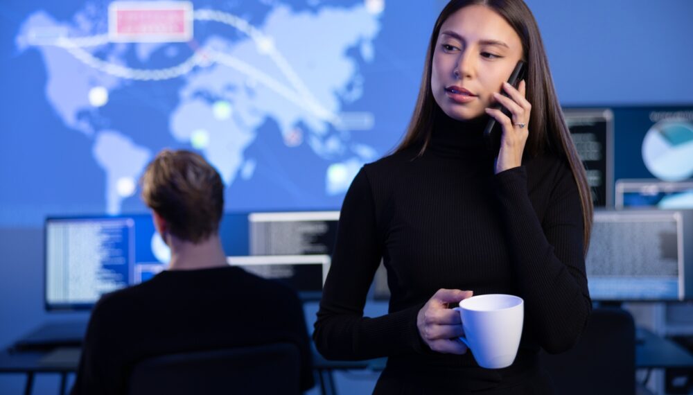 Female Cybersecurity Manager talking in the phone in Enterprise Cyber Security Operations Center SOC