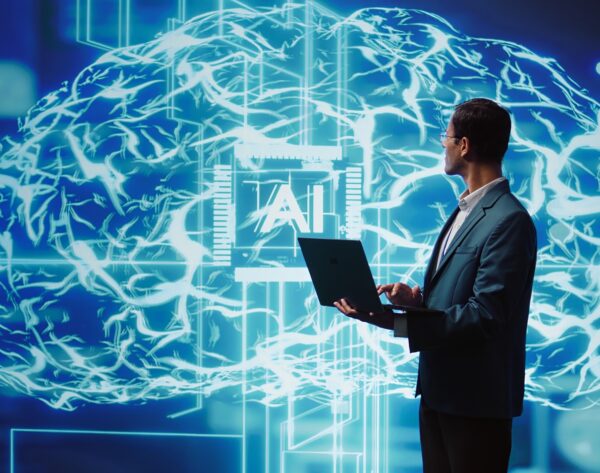 Man using notebook to write lines of code for AI applications Man using notebook to write lines of code for AI applications