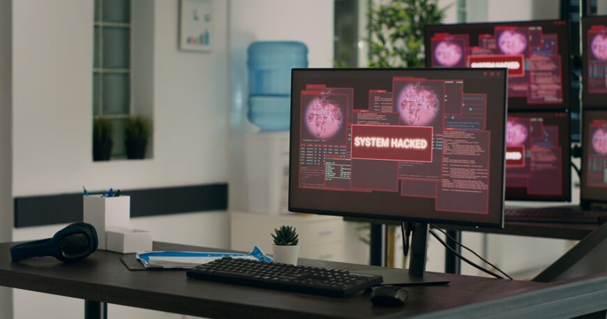 Computers displaying hacking attack alert and security breach