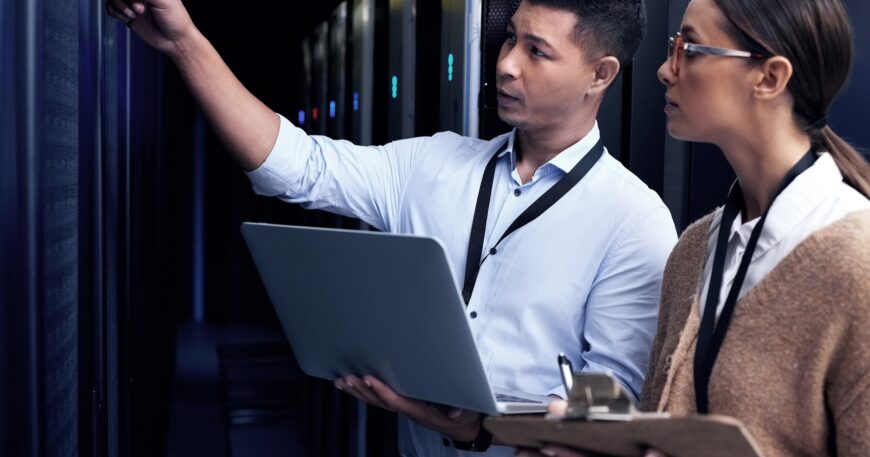 Its not safe until IT support says so. Shot of two technicians working together in a server room.
