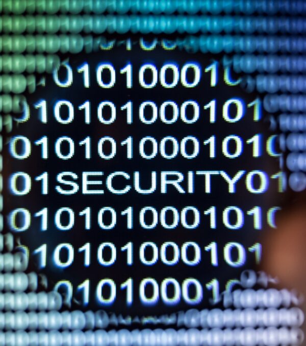 Word security written in binary code with magnifying glass